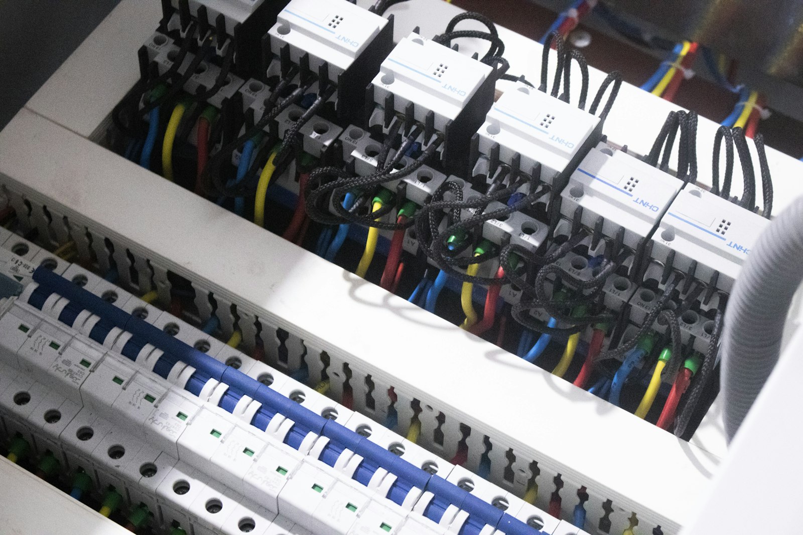 Bundle of colored electrical wires plugged into a switch box